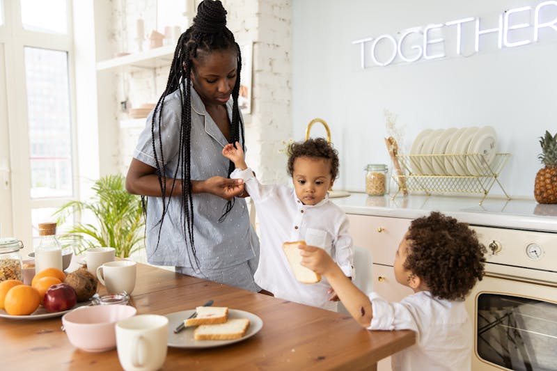 Family enjoying healthy breakfast together in sunny kitchen. Family health/Healthy family place